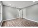 A bedroom featuring gray walls, wood floors, closet, and a light-filled window at 3312 Blythe Ave, Spring Hill, FL 34609