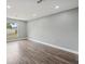 Bright, airy bedroom featuring luxury vinyl plank flooring and a window at 3312 Blythe Ave, Spring Hill, FL 34609