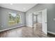 Bright bedroom with hardwood floors, large window, and open doorway offers a spacious and airy feel at 3312 Blythe Ave, Spring Hill, FL 34609