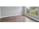 Bright bedroom with wood floors, neutral paint, large window, and white trim at 3312 Blythe Ave, Spring Hill, FL 34609