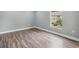 Bedroom with wood-look flooring and a window with a view of the outdoors at 3312 Blythe Ave, Spring Hill, FL 34609