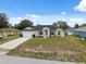 Inviting single-story home with a lush lawn, two-car garage, and a well-maintained front yard at 3312 Blythe Ave, Spring Hill, FL 34609