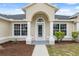 Close-up of the front entrance, featuring a covered porch and detailed architecture at 3312 Blythe Ave, Spring Hill, FL 34609
