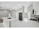 Modern kitchen with stainless steel appliances, an island sink and new flooring for a clean look at 3312 Blythe Ave, Spring Hill, FL 34609