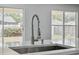Close up of the kitchen sink featuring stainless steel pull-down faucet at 3312 Blythe Ave, Spring Hill, FL 34609