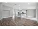Spacious open-concept living area with hardwood floors, bright natural light and flows into the kitchen at 3312 Blythe Ave, Spring Hill, FL 34609
