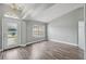 Spacious living room with wood floors, modern lighting, and lots of natural light at 3312 Blythe Ave, Spring Hill, FL 34609