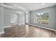 Bright living room with elegant wood floors, neutral paint, and a large window at 3312 Blythe Ave, Spring Hill, FL 34609