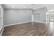 Large living room featuring new hardwood floors, large windows, and lots of bright natural light at 3312 Blythe Ave, Spring Hill, FL 34609