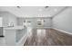 Open living room with wood floors, white trim, and large windows allowing for an abundance of natural light at 3312 Blythe Ave, Spring Hill, FL 34609