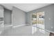 A living room featuring tile flooring and a sliding glass door to the backyard at 3312 Blythe Ave, Spring Hill, FL 34609