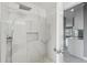 A luxury shower featuring marble tile walls, shower head, and recessed storage at 3312 Blythe Ave, Spring Hill, FL 34609