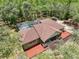 Aerial view of the home with a pool, landscaped yard, and spacious layout at 34335 Berryhill Dr, Webster, FL 33597