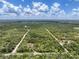 Expansive aerial view highlighting the property's vast wooded acreage and dirt road at 34335 Berryhill Dr, Webster, FL 33597