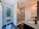 Bathroom features a double sink with granite countertops, a walk-in shower, and access to the pool area at 34335 Berryhill Dr, Webster, FL 33597