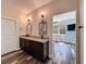 Bathroom has double sink vanity with granite countertop, decorative sconces, and modern mirrors at 34335 Berryhill Dr, Webster, FL 33597