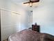Bedroom featuring wood-look floors, ceiling fan, and closet at 34335 Berryhill Dr, Webster, FL 33597