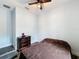 Bedroom featuring wood-look floors, ceiling fan, and chest of drawers at 34335 Berryhill Dr, Webster, FL 33597