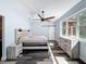 Bright bedroom featuring hardwood style floors, decorative ceiling fan, and rustic wood furniture at 34335 Berryhill Dr, Webster, FL 33597