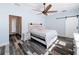 Bedroom featuring hardwood style floors, rustic wood furniture, decorative ceiling fan, and natural light at 34335 Berryhill Dr, Webster, FL 33597