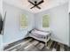 Bright bedroom with hardwood-style flooring, a ceiling fan, and ample natural light at 34335 Berryhill Dr, Webster, FL 33597