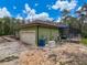 Side view of home with screened in pool, garage, and generator at 34335 Berryhill Dr, Webster, FL 33597