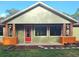 Single-story home with a new roof, a bright red front door, and delightful flower box accents on the porch at 34335 Berryhill Dr, Webster, FL 33597