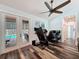 Room featuring access to the pool area through french doors, hardwood style floors, and a treadmill at 34335 Berryhill Dr, Webster, FL 33597