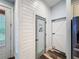 Bright hallway features shiplap walls, a pantry door, and access to other rooms at 34335 Berryhill Dr, Webster, FL 33597