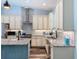 Bright kitchen boasts granite countertops, stainless steel appliances, white cabinets and a stainless steel range hood at 34335 Berryhill Dr, Webster, FL 33597