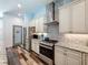 Modern kitchen features stainless steel appliances, gas range, granite counters, white cabinets, and a pantry at 34335 Berryhill Dr, Webster, FL 33597