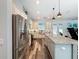 Open concept kitchen featuring stainless steel appliances and an island with granite countertops at 34335 Berryhill Dr, Webster, FL 33597
