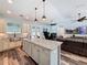 Bright, open kitchen with granite countertops, a kitchen island and views to the living area at 34335 Berryhill Dr, Webster, FL 33597