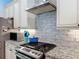 Modern kitchen featuring stainless steel appliances, granite countertops, and stylish white cabinetry at 34335 Berryhill Dr, Webster, FL 33597