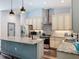 Bright kitchen with granite countertops, stainless steel appliances, large island, and a door to the pantry at 34335 Berryhill Dr, Webster, FL 33597