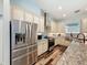 Well-equipped kitchen featuring stainless steel appliances, granite countertops, and a large island at 34335 Berryhill Dr, Webster, FL 33597