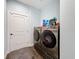 Modern laundry room features front loading Samsung washer and dryer set and tiled floors at 34335 Berryhill Dr, Webster, FL 33597