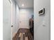 Hallway with laundry room to the right and decorative door at 34335 Berryhill Dr, Webster, FL 33597
