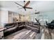 Spacious living room featuring hardwood style floors, leather sectional sofa, modern ceiling fans, and an open floorplan at 34335 Berryhill Dr, Webster, FL 33597