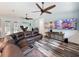 Spacious living room featuring a comfortable leather sofa, modern TV, and stylish flooring at 34335 Berryhill Dr, Webster, FL 33597