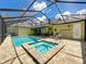 Stunning screened-in pool and spa with lounge chairs, ideal for outdoor relaxation and entertaining at 34335 Berryhill Dr, Webster, FL 33597