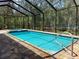 Screened-in pool and hot tub with brick paver deck at 34335 Berryhill Dr, Webster, FL 33597
