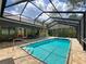 Relaxing screened-in pool with spa and outdoor entertaining area at 34335 Berryhill Dr, Webster, FL 33597