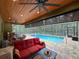 Covered outdoor space with a large in-ground pool, seating, and dining area at 34335 Berryhill Dr, Webster, FL 33597