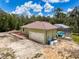 Back view of a home with a screened-in pool and a spacious backyard at 34335 Berryhill Dr, Webster, FL 33597