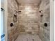 An elegant walk-in shower with decorative tiles and dual shower heads for a luxurious experience at 34335 Berryhill Dr, Webster, FL 33597