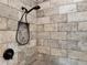 Close-up of a walk-in shower with tiled walls, recessed shower niche, and bronze fixtures at 34335 Berryhill Dr, Webster, FL 33597
