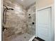 A walk-in shower featuring tiled walls and flooring, with recessed shower niche at 34335 Berryhill Dr, Webster, FL 33597