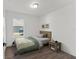Stylishly decorated bedroom featuring a window for natural light and dark wood flooring at 3554 Arrowhead Ave, Spring Hill, FL 34606