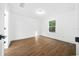 Bright bedroom featuring wood floors, natural light, and ample space at 3554 Arrowhead Ave, Spring Hill, FL 34606
